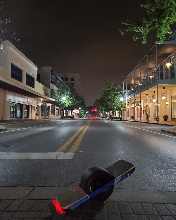 Onewheel electric board on an empty downtown Pensacola street at night