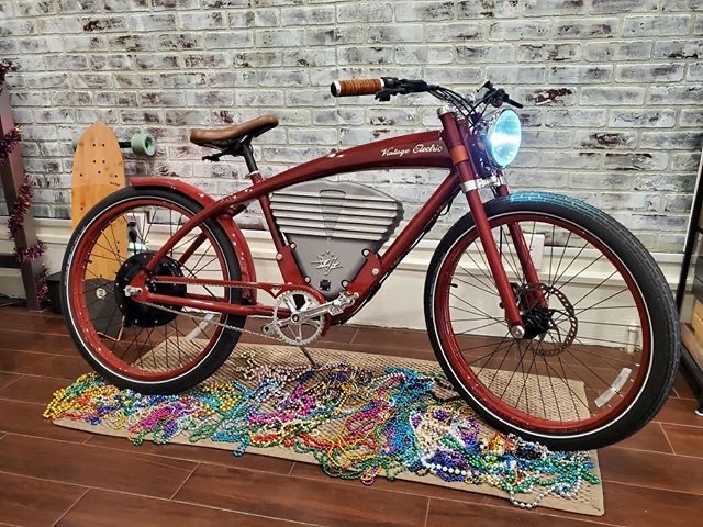 Vintage Electric cruiser bike on display with Mardi Gras beads