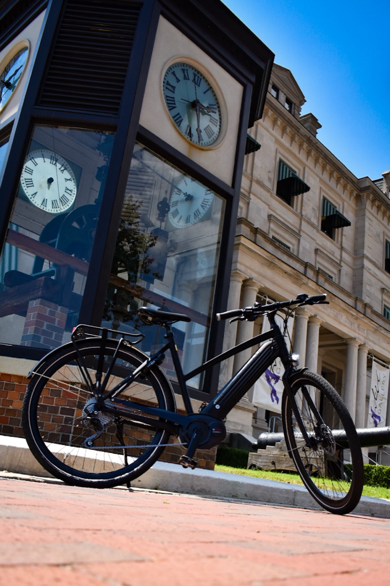 Electric bike parked beside the clock tower in downtown Pensacola