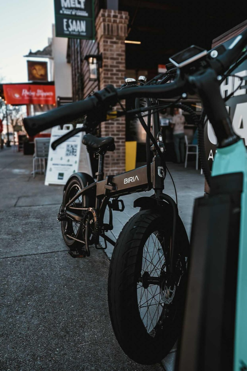 Biria folding electric bike parked outside a downtown Pensacola restaurant